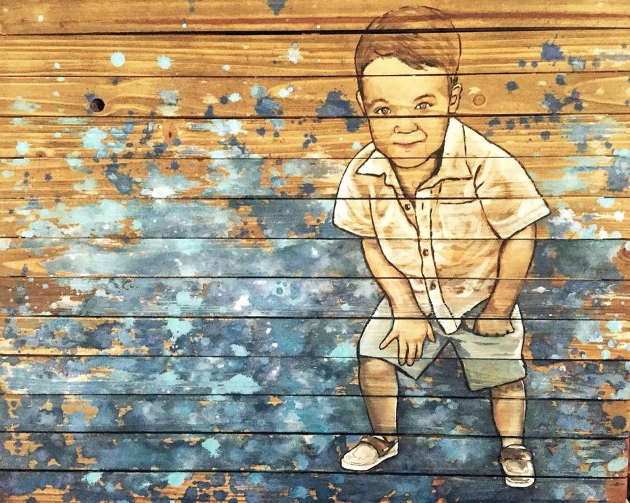 Boy on blue barn wood