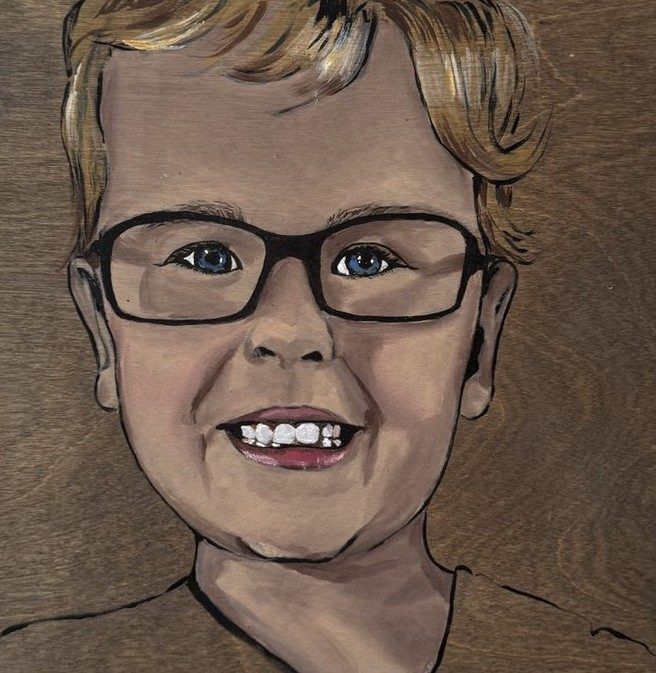 Boy with glasses, on wood